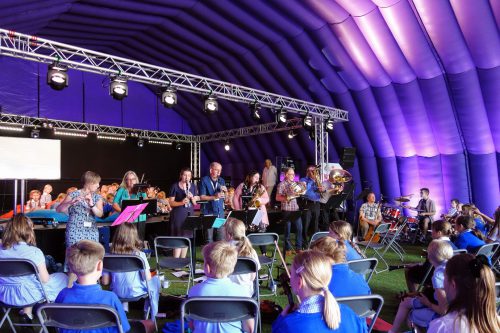 Teachers playing at Celebration in purple tent