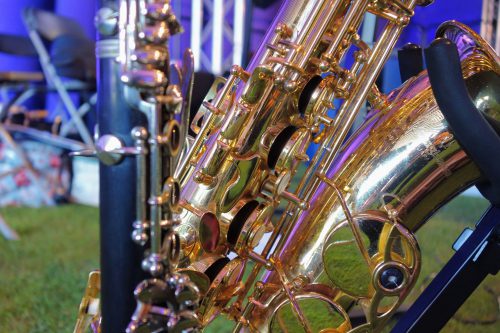 End of saxphone in stand with clarinet in foreground